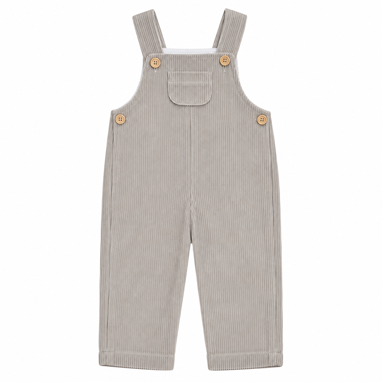 Vista frontal completa del peto de pana beige para niños y niñas, confeccionado con tejido elástico y tirantes ajustables con botones de madera, producto elaborado en España.